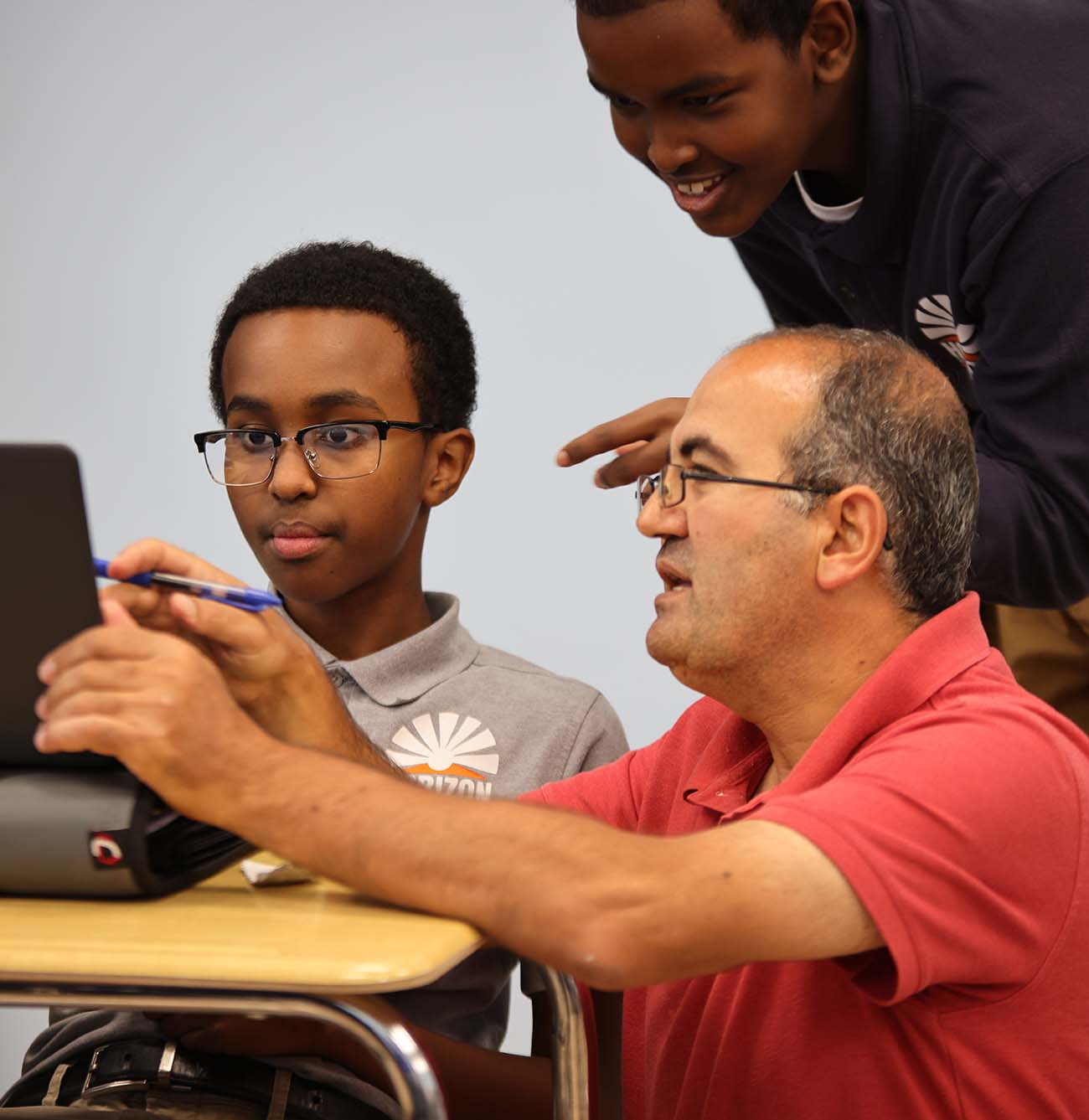HSA Columbus Middle student wearing headphones uses a laptop in class