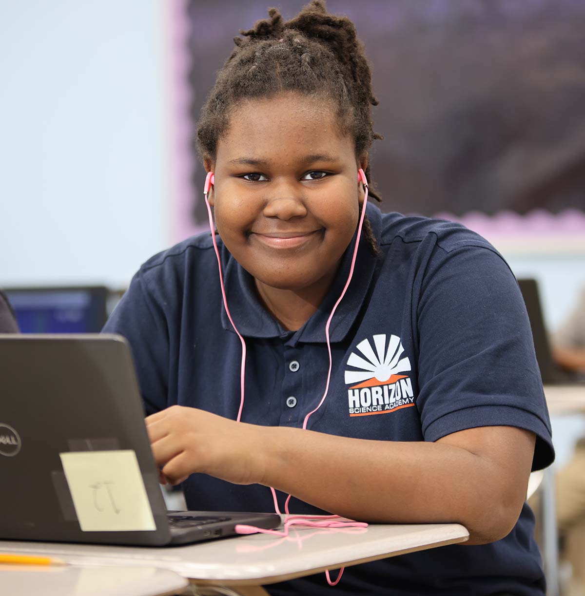 Student drawing in a classroom.